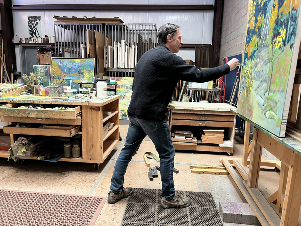 Rick Stevens painting at the easel in his Santa Fe, NM studio.