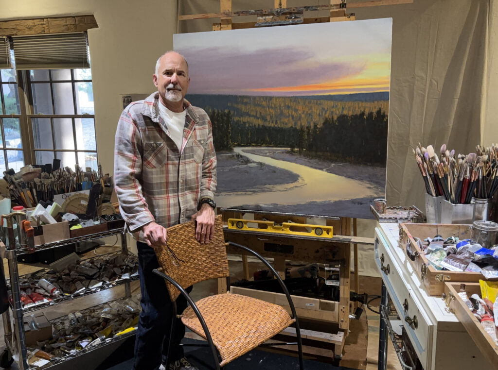 Peter Campbell in the studio with "Call of the River" on the easel.